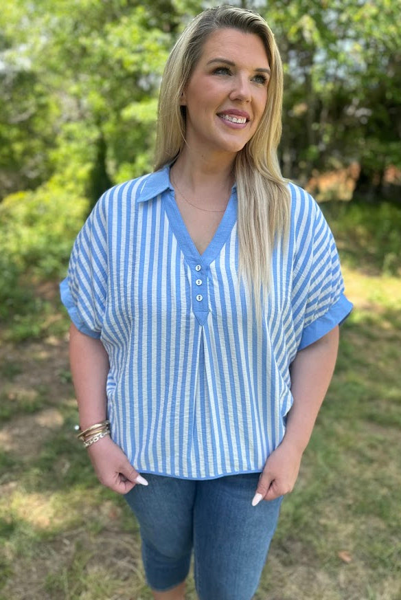 Woman wearing a blue and white striped shirt outdoors