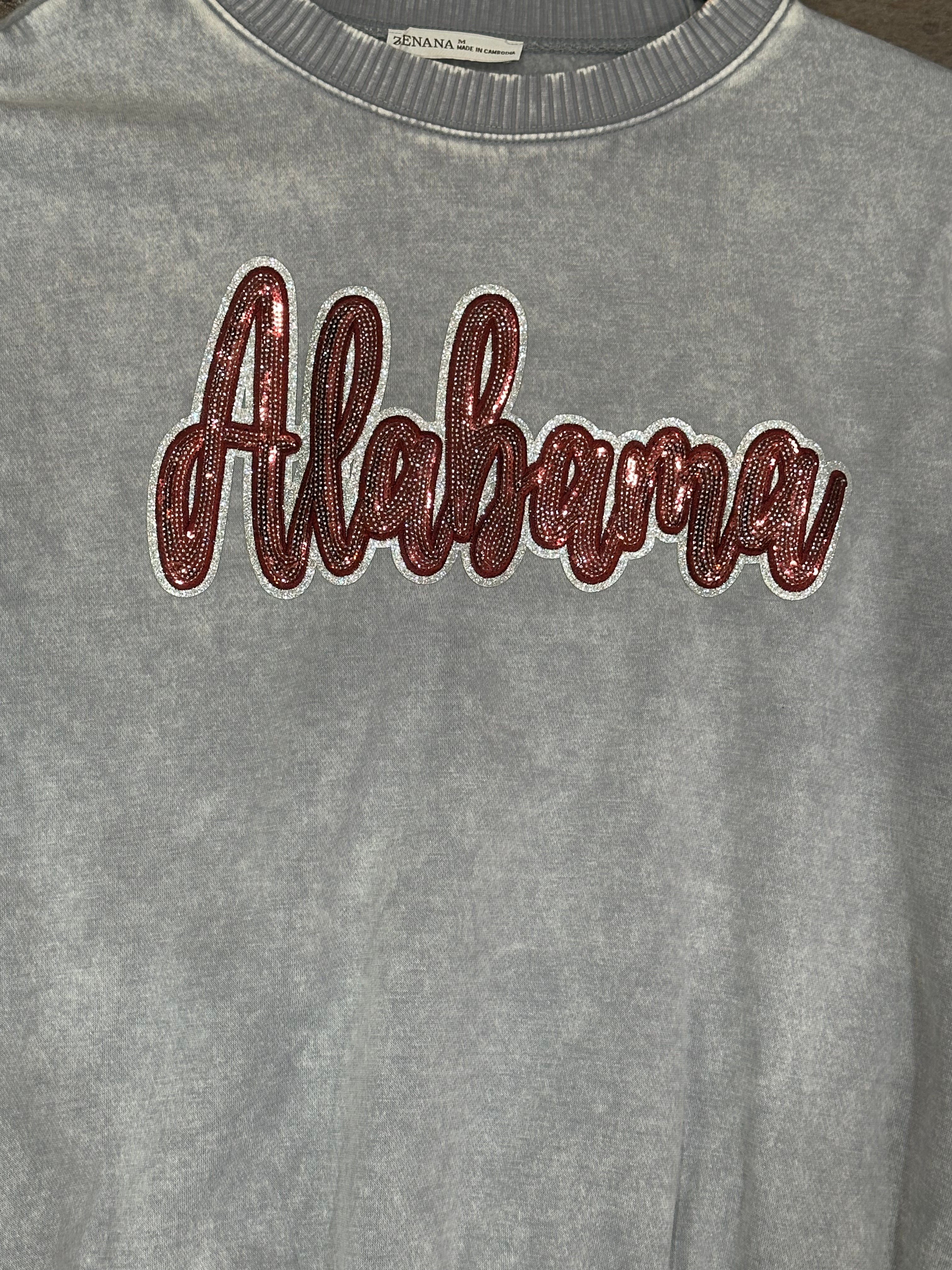 Gray sweatshirt with 'Alabama' text in maroon on a plain background