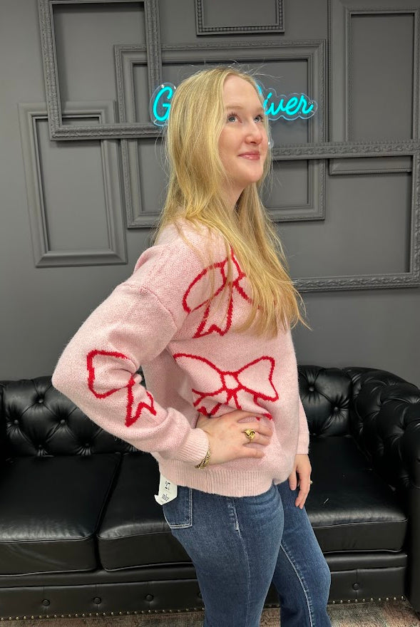 pink bow sweater, holiday sweater, girly knit top, cozy winter sweater, red and pink sweater, boutique knitwear, bow print top, women’s boutique sweater, cute holiday outfit, cozy chic sweater