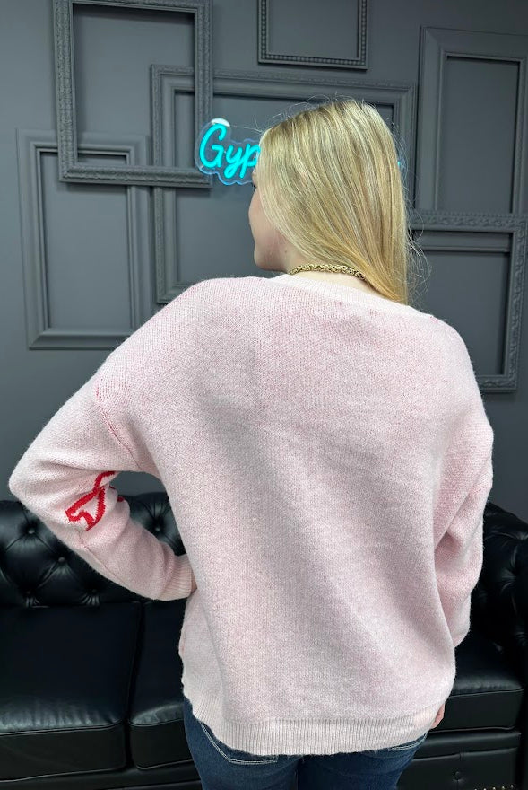 pink bow sweater, holiday sweater, girly knit top, cozy winter sweater, red and pink sweater, boutique knitwear, bow print top, women’s boutique sweater, cute holiday outfit, cozy chic sweater
