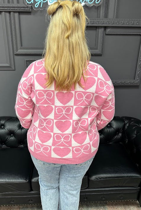 Flattering V-neckline
Ribbed cuffs, neckline, and hem
Relaxed fit that’s easy to wear
bow and heart sweater, V neck sweater, Valentine sweater, heart pattern sweater, women’s novelty sweater, boutique sweaters, Gypsy River Apparel