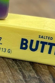 Three colorful butter bars on a wooden surface with a blurred background