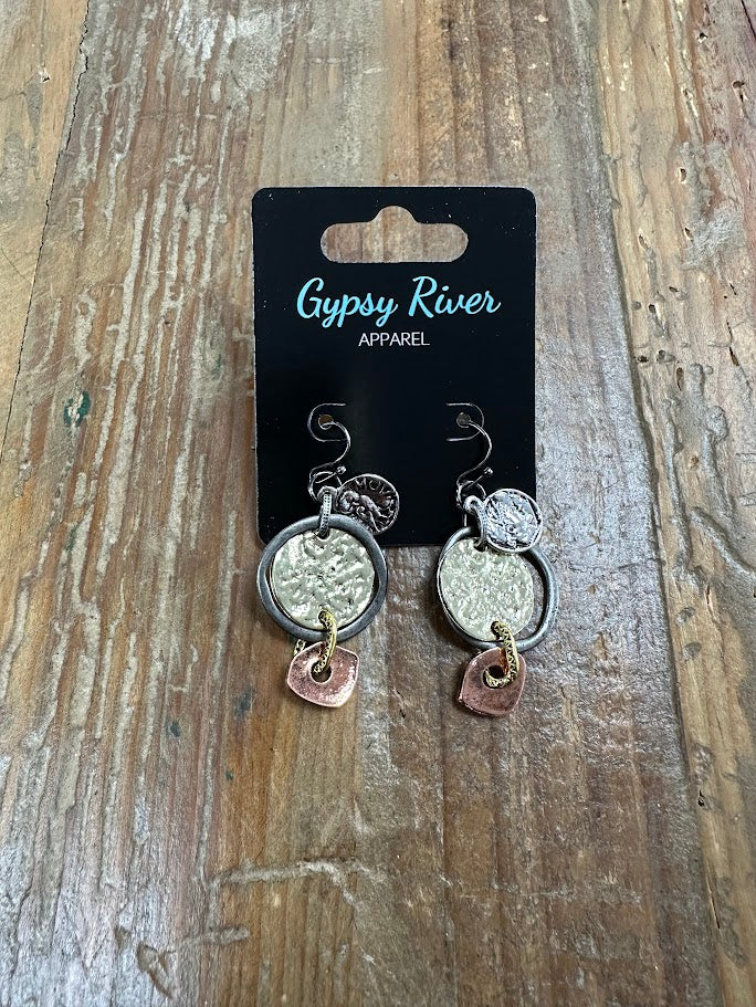 Layered mixed-metal coin earrings with hammered texture and copper accents. Lightweight, eye-catching, and full of character.
