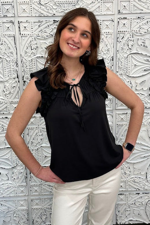 Liverpool black sleeveless blouse with ruffle trim and tie front neckline on model