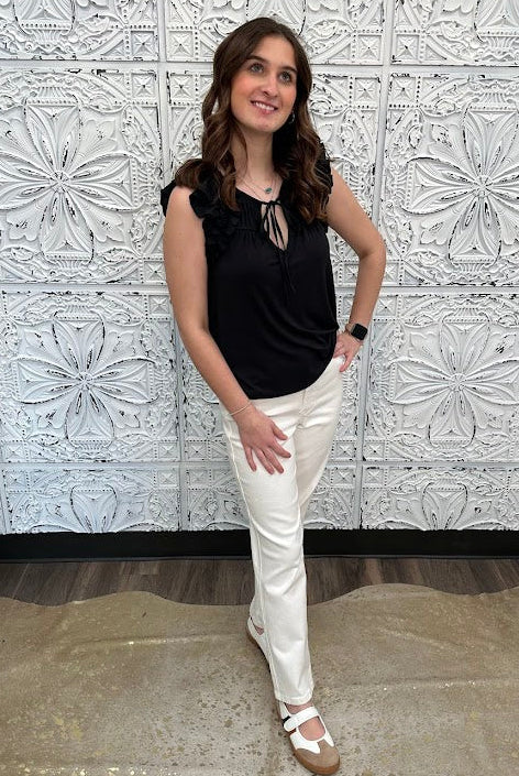 Liverpool black sleeveless blouse with ruffle trim and tie front neckline on model