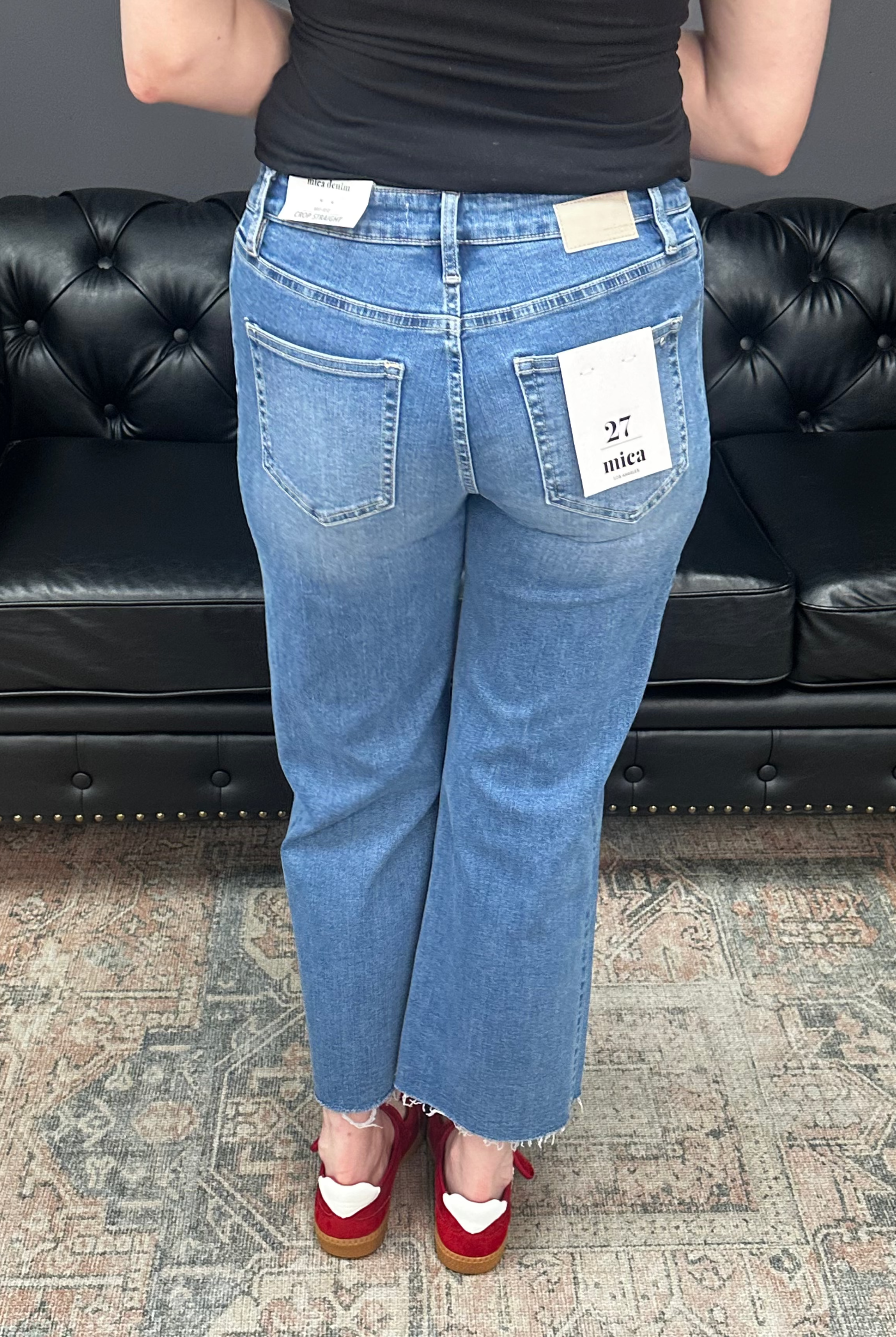 Mid rise tummy tuck cropped straight jeans with raw hem and vertical seam detail for women