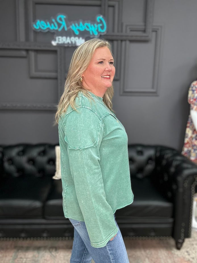 Woman wearing green washed Easel long sleeve top with front yoke seam detail and casual fit.