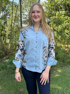 blue floral blouse, ruffle v-neck top, button down floral shirt, long sleeve blouse women, lightweight fall blouse, floral print top, dressy casual blouse, work to weekend top, feminine floral blouse, boutique button shirt, chic office top, floral sleeve blouse, elegant ruffle neckline top, blue floral print shirt, stylish women’s blouse, soft cotton blend blouse, fall floral top, Gypsy River Apparel, Northport boutique clothing, versatile everyday blouse
