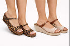 Two pairs of sandals, one leopard print and one beige with brown straps, on a white background.