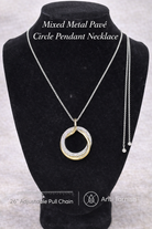 Mixed metal pavé circle pendant necklace on a black bust with product details.
