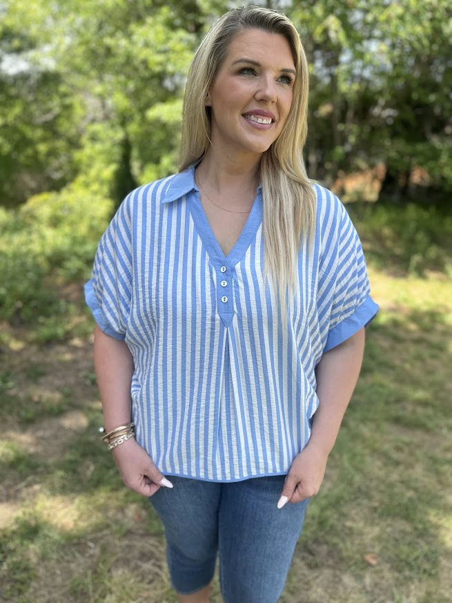Woman wearing a blue and white striped shirt outdoors