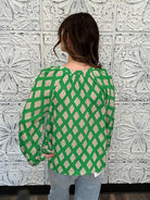 green printed blouse, pink print top, boutique women’s blouse, bold statement blouse, relaxed fit long sleeve top, colorful work blouse