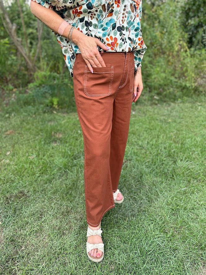 high waist wide leg pants, rust cropped pants, exposed stitch detail pants, casual fall trousers, women’s boutique pants, front pocket pants, straight leg cotton pants, relaxed fit pants, rust brown pants, high rise crop pants, comfy everyday bottoms, wide leg trousers for women, autumn outfit pants, boutique style pants, chic rust trousers, easy fit pants, neutral fall wardrobe, Northport boutique fashion, Gypsy River Apparel