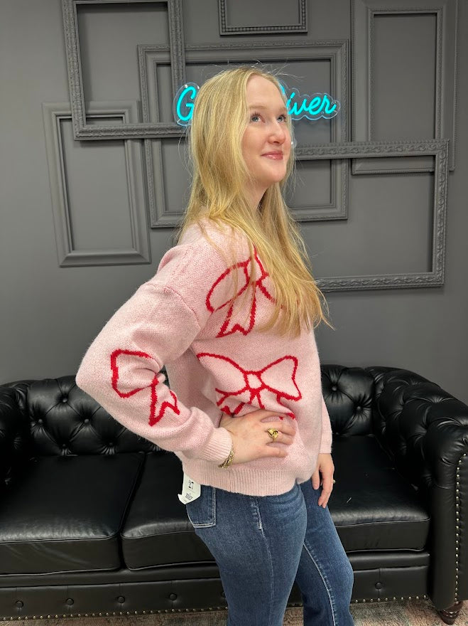 pink bow sweater, holiday sweater, girly knit top, cozy winter sweater, red and pink sweater, boutique knitwear, bow print top, women’s boutique sweater, cute holiday outfit, cozy chic sweater