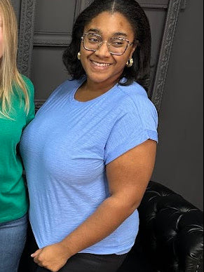 Three women posing together in front of a 'Gypsy River Apparel' sign.