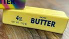 Three colorful butter bars on a wooden surface with a blurred background