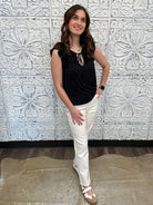 Liverpool black sleeveless blouse with ruffle trim and tie front neckline on model