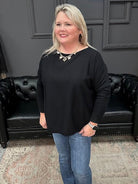 Woman standing in a store with a Christmas tree and 'Gypsy River Apparel' sign.