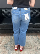 Mid rise tummy tuck cropped straight jeans with raw hem and vertical seam detail for women