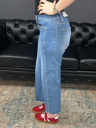 Mid rise tummy tuck cropped straight jeans with raw hem and vertical seam detail for women