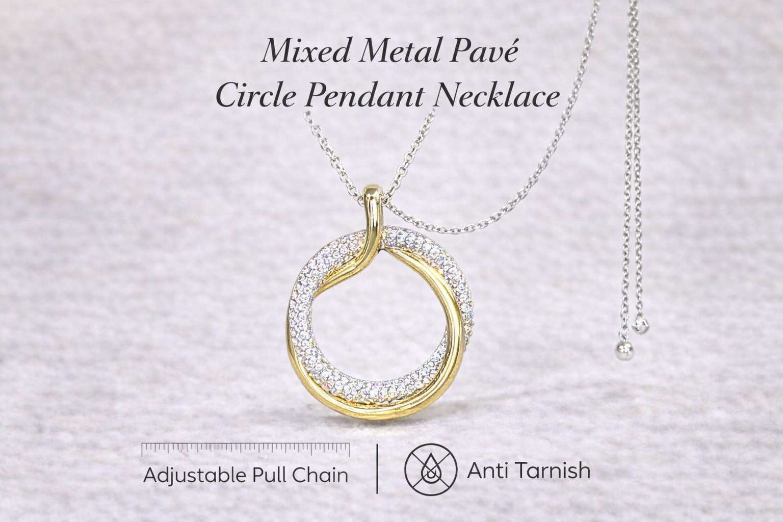Gold and silver mixed metal pavé circle pendant necklace on a light gray background