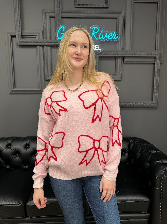 pink bow sweater, holiday sweater, girly knit top, cozy winter sweater, red and pink sweater, boutique knitwear, bow print top, women’s boutique sweater, cute holiday outfit, cozy chic sweater