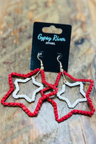 Red and silver star-shaped earrings on a wooden surface with 'Gypsy River Apparel' card.