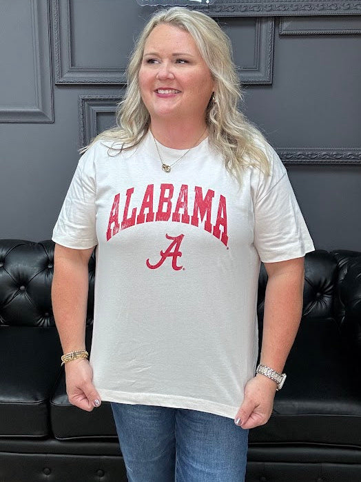 Person wearing an Alabama t-shirt in a room with a black couch and 'Gypsy River Apparel' sign.
